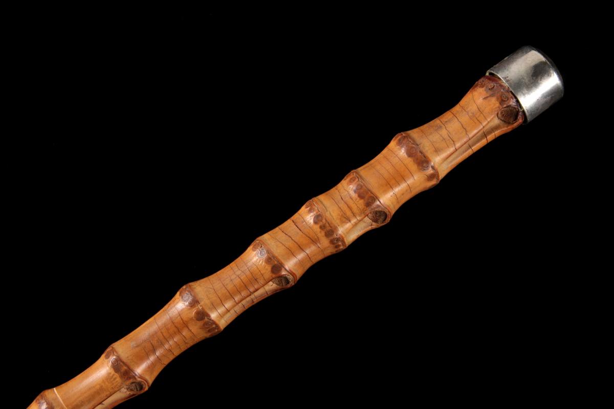 A BAMBOO WALKING STICK WITH STERLING SILVER