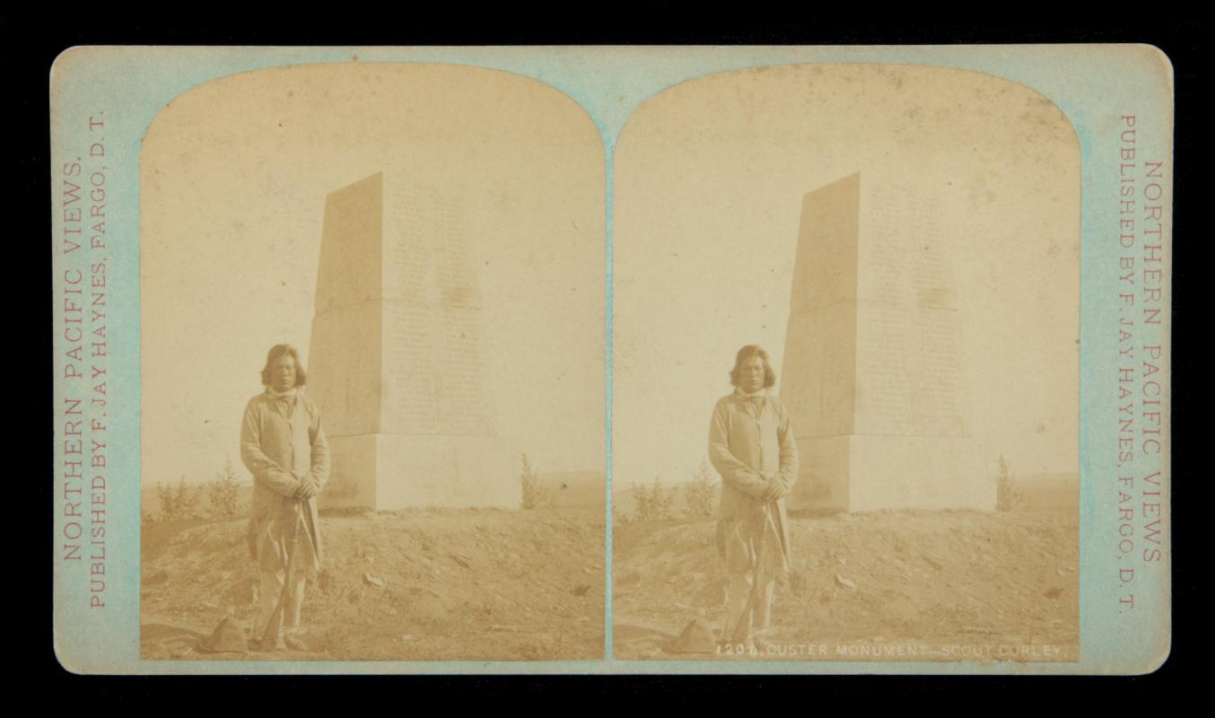 A STEREOVIEW OF SCOUT CURLEY AT CUSTER MONUMENT