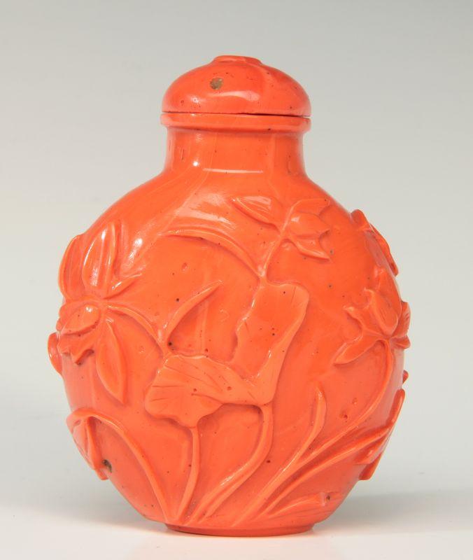 A CHINESE CARVED CORAL SNUFF BOTTLE