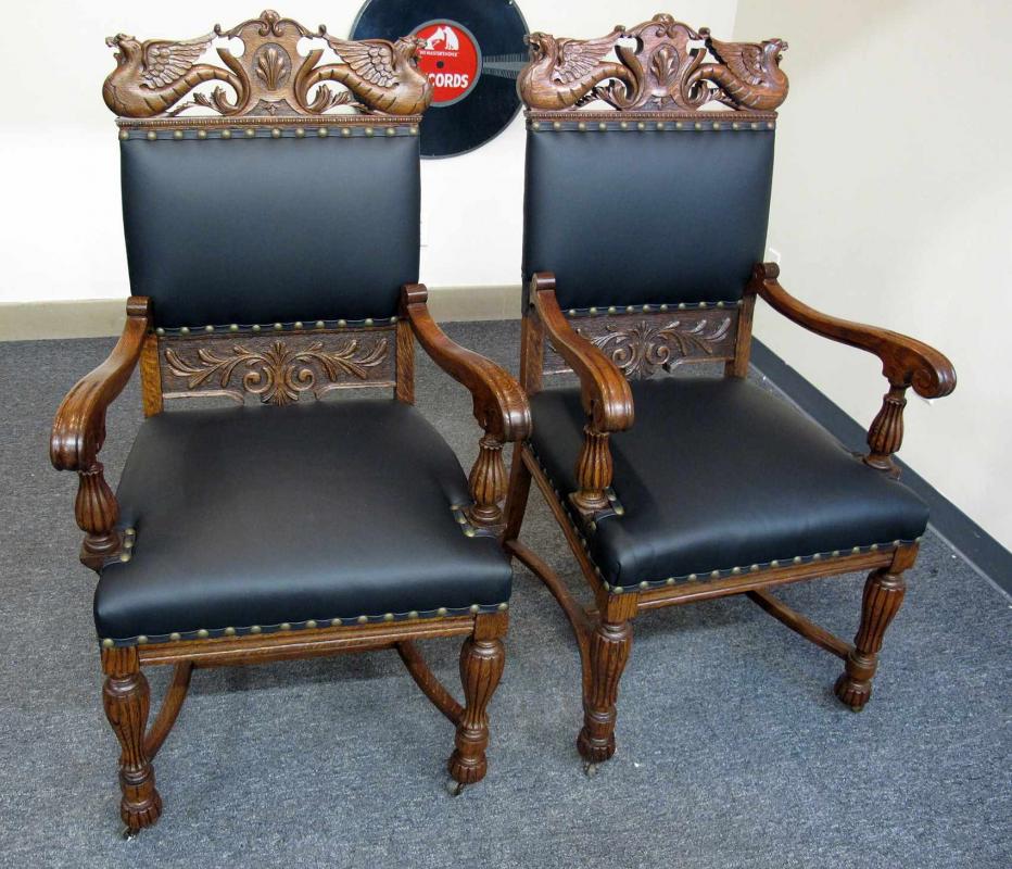 A PAIR QUARTERSAWN OAK WINGED GRIFFIN ARM CHAIRS