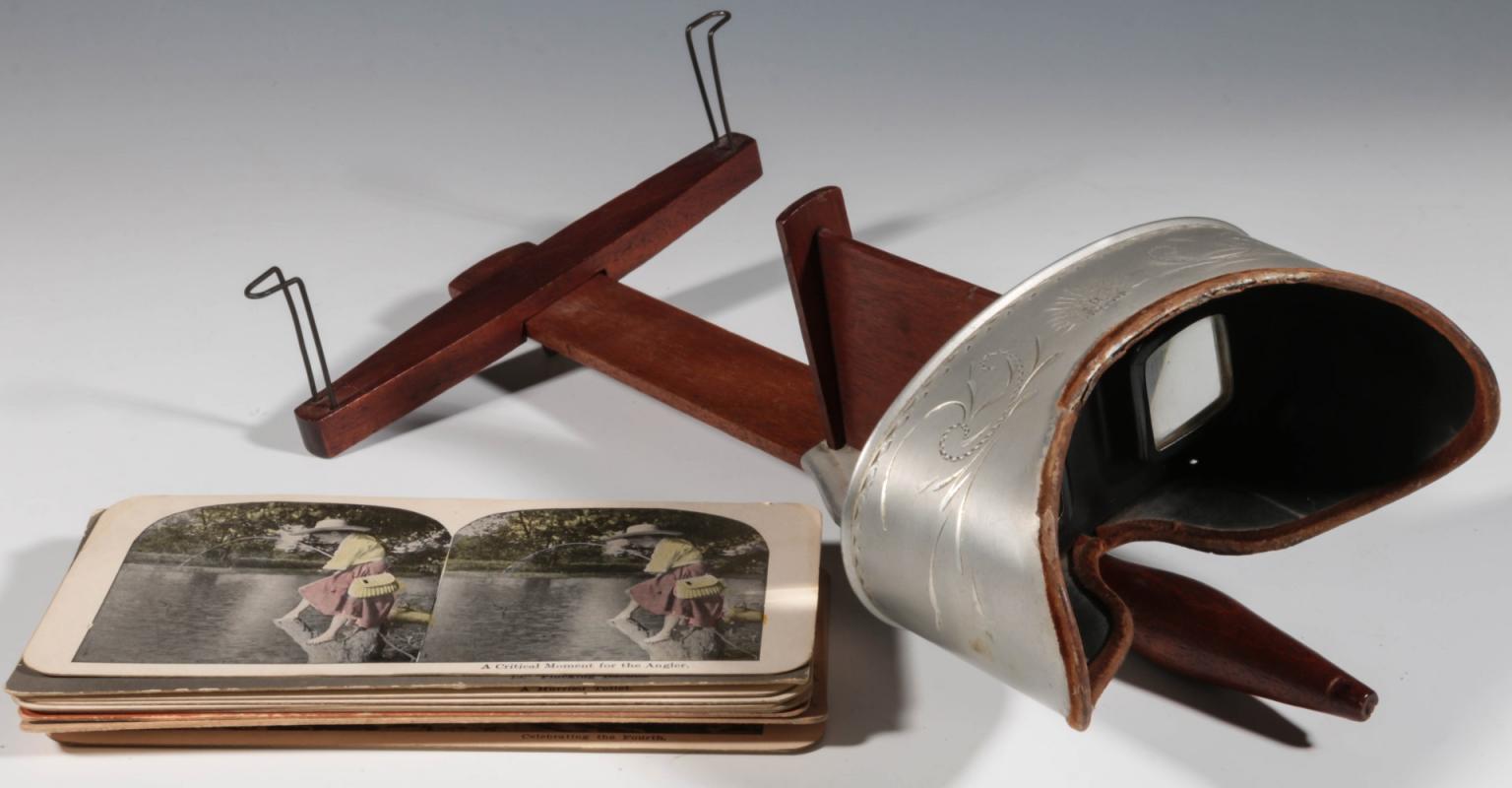 AN ANTIQUE STEREOVIEWER WITH CARDS