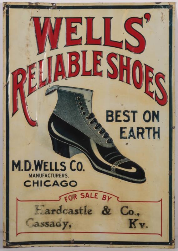 AN EARLY 20THC. EMBOSSED TIN SIGN FOR WELLS' SHOES